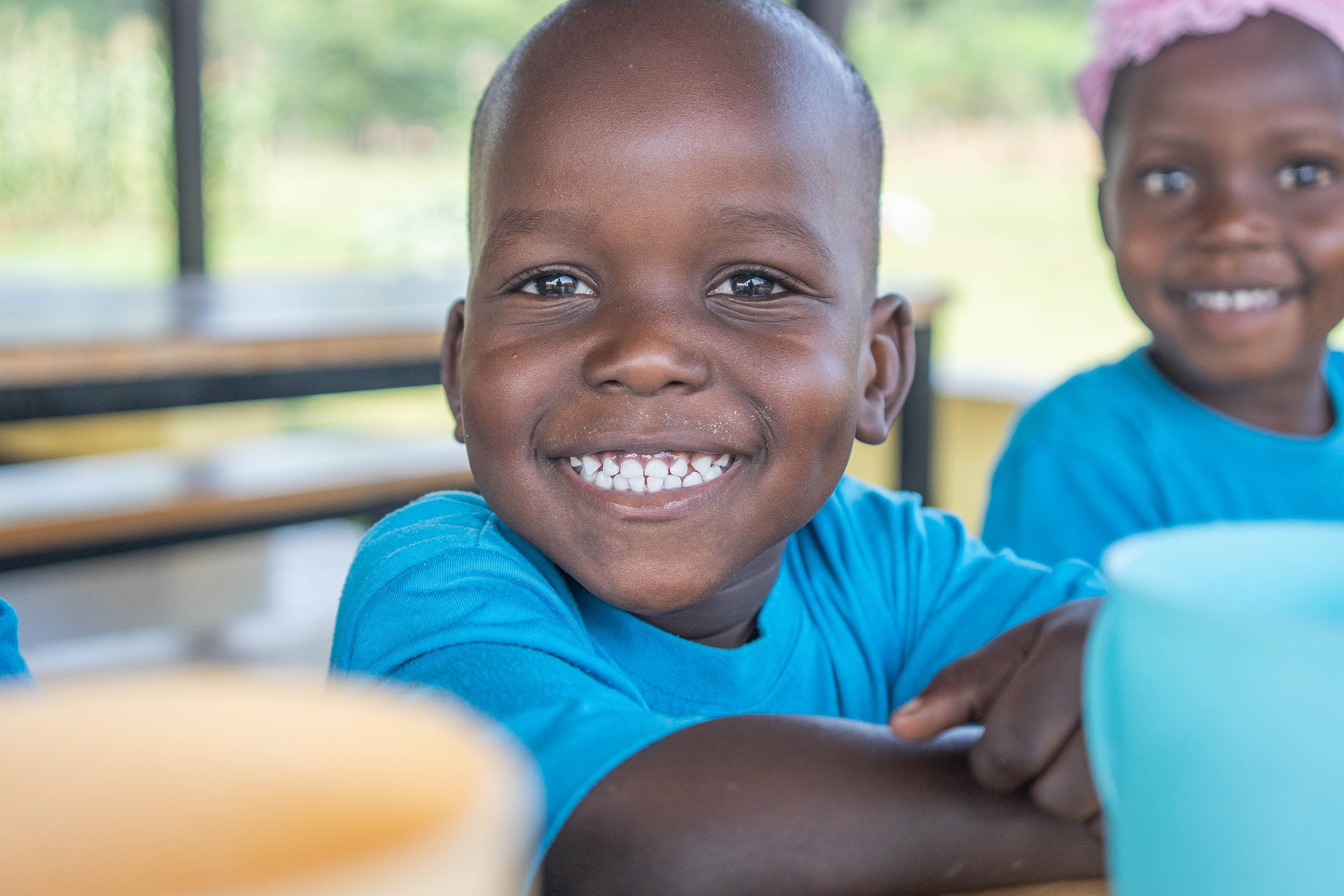 A preschooler smiling at New Beginnings Nursery School